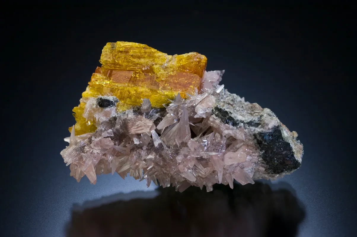 Legrandite: Orange-yellow crystals of legrandite with pale pink smithsonite and white leiteite. 40 mm specimen. MGMH Collection 2020.7.787.